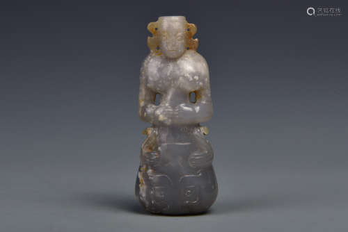A CARVED JADE STANDING FIGURE