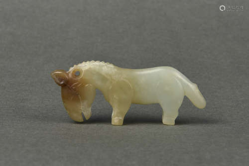 A WHITE AND RUSSET JADE HORSE SHANG DYNASTY