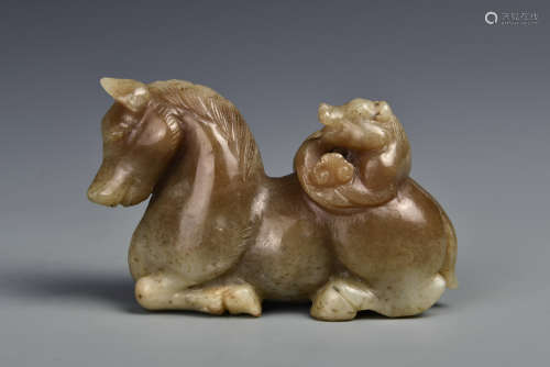 A CARVED CREAMY WHITE JADE AND RUSSET HORSE QING DYNASTY