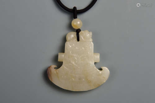 A WHITE AND RUSSET JADE AXE 13TH CENTURY