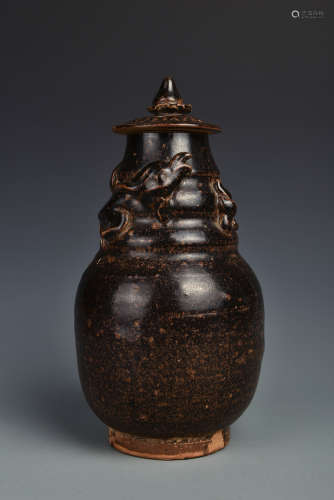 A BROWN GLAZED JAR AND COVER