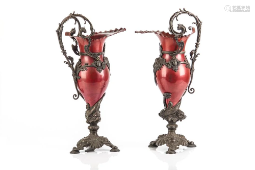 PAIR OF CAST BRONZE AND RED PAINTED METAL EWERS