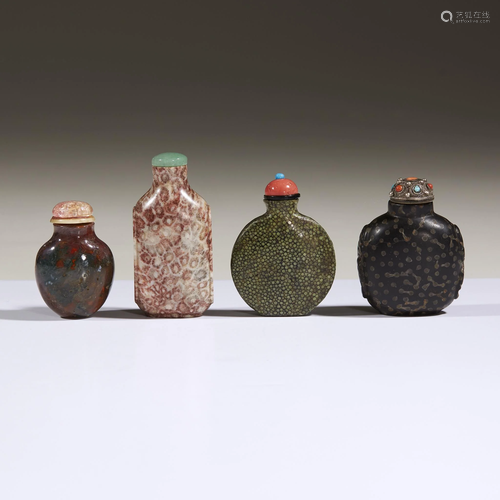 Three Chinese carved hardstone snuff bottles and a …