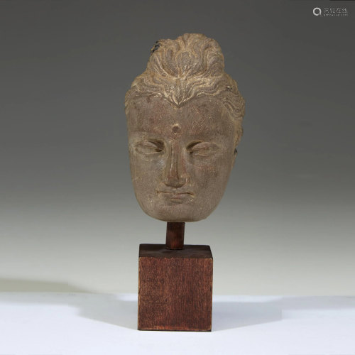 A Gandharan carved stone face of a Buddha
