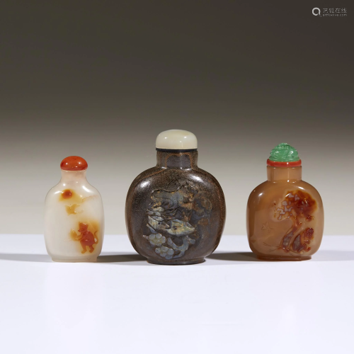 Three Chinese carved hardstone snuff bottles,