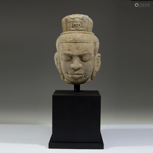 A Khmer style carved beige stone head of a Buddha,