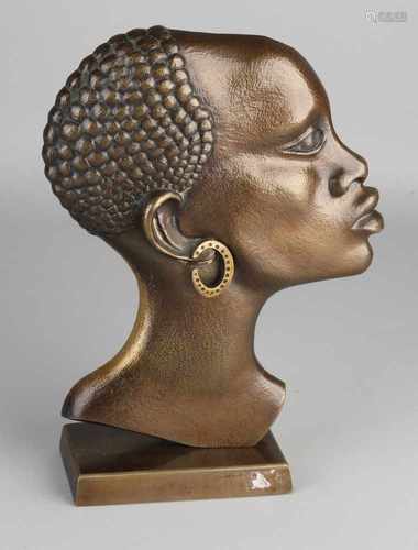 Bronze bust of an African woman. 20th century. Signature J.J.S. and A.M.A. Size: 28 x 20 x 6.5 cm.