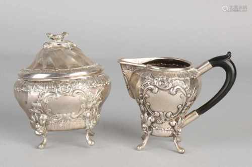 Antique silver cream-set, with a milk jug, with wooden handle, and suikerbak, both decorated with