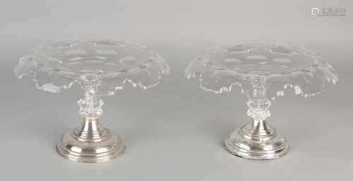 Two crystal tazza with folded edge placed on a round base with silver pearl edge, 833/000. ø20x14cm.