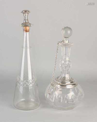 Two decanters with silver high carafe with cut edge with star and capped includes engraving and