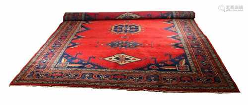 Persian rug in red / blue with several medallions in the middle. Size: 300 x 400 cm.