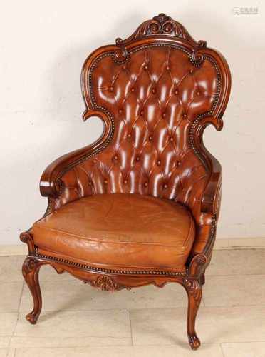 Italian walnut armchair with brown leather trim. Second half 20th century. Size: 120 x 85 x 75 cm.