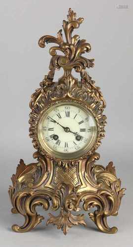 Antique French brass pendulum in Rococo style. Eight day-movement, half-hour stroke and spring roll.