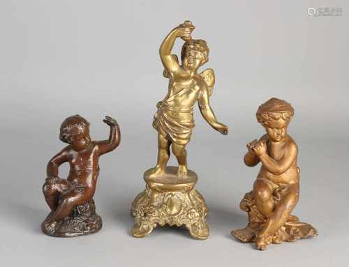 Three antique metal figures. Among other things: one time putti of metal composition, once bronze,