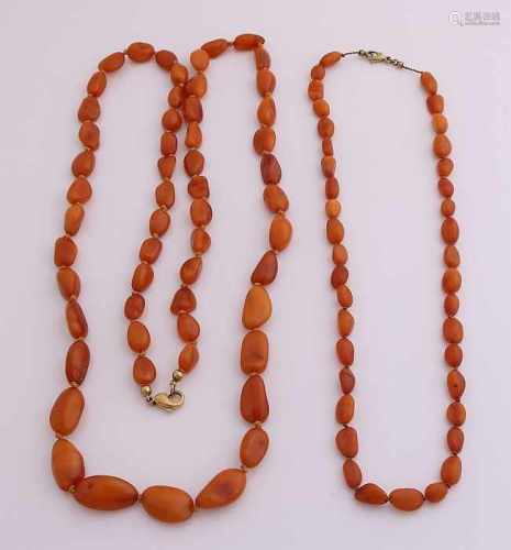 Two necklaces of amber, nugget-shaped, translucent beads, fitted with a snap hook closure, 333/