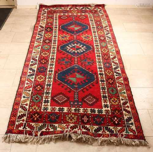 Persian rug in the colors red, blue, cream. Size: 119 x 280 cm. In good condition.