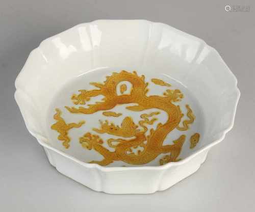 Chinese white glazed porcelain bowl with orange dragon decor and molded rim. Six signs bottom