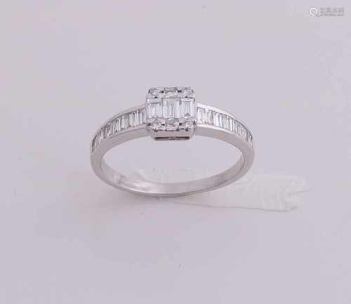 Graceful white gold ring, 750/000, with diamond. Ring with a rail with baguette cut diamonds,