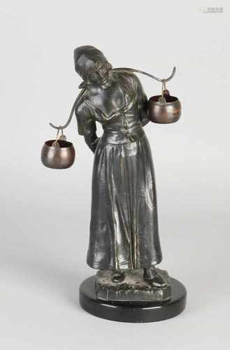 Antique metal milk composition girl on black marble base. Circa 1920. Dimensions: H 26 cm. In good