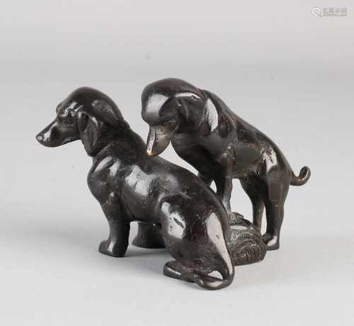 Antique bronze sculpture group. Two dachshunds in trunk. Circa 1900. Size: 7 x 10 x 9 cm. In good