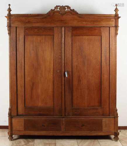 Solid oak two-door cabinet with a small tuft inserted. Under with two drawers. Circa 1860.