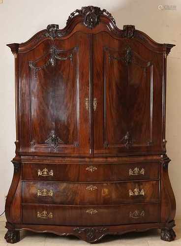 18th Century Dutch mahogany convex Louis Seize cabinet with brass fittings and carved garlands.