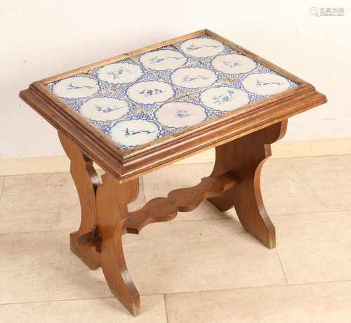 Oak table with twelve pieces of 17th century Dutch wall tiles with animals. Damages. Size: 55 x 46 x