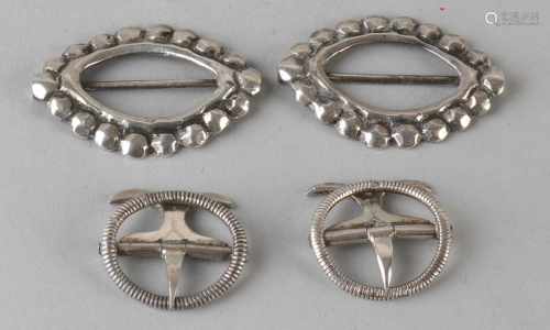 Two pairs of silver buckles calf, 833/000, one pair of oval knerrenrand. 23x26mm, and a pair of