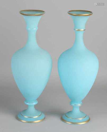 Two antique opaline glass vases with goudomranding. Circa 1900. Dimensions: H 30 x Ø 10 cm. In