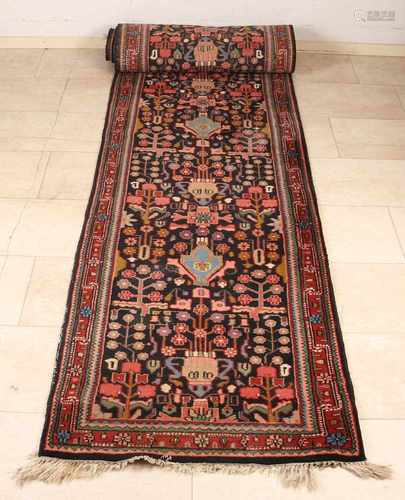 Long Persian carpet with floral decor. Size: 77 x 410 cm. In good condition.