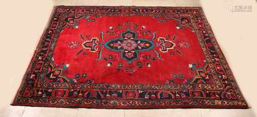 Big red Persian rug with multicolored floral decors. Size: 167 x 200 cm. In good condition.