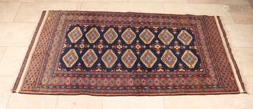 Old Persian rug in blue / black / brown. Floral decor. Size: 88 x 168 cm. In good condition.