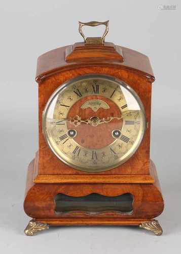 Carrot Walnut Warmink table clock with bronze legs. Half-hour battle on call. Second half 20th