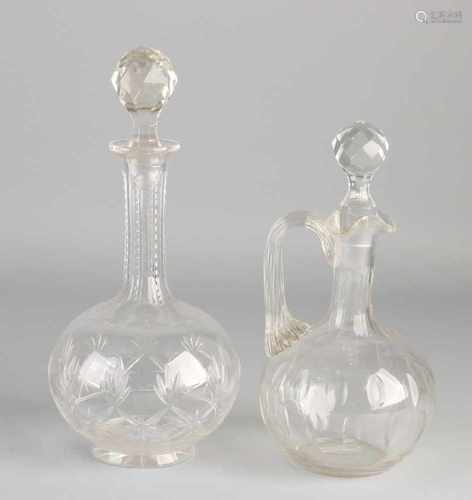 Two antique crystal decanters. One meal with almond sharps. One times with floral facet grindings.