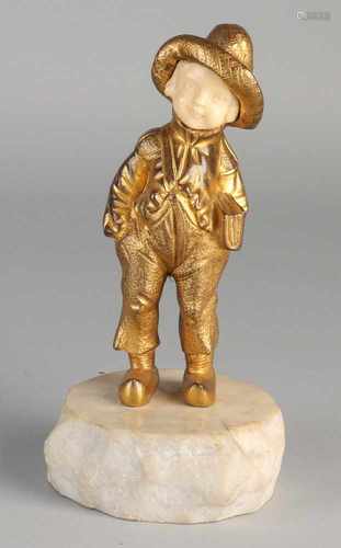 Antique gilt bronze figure with ivory face on marble base. Circa 1900. Boy with book clogs. Size: