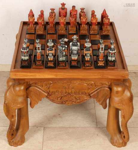 Indonesian wood inserted (teak) chess with elephant feet and carving on leaf. Blade is reversible to