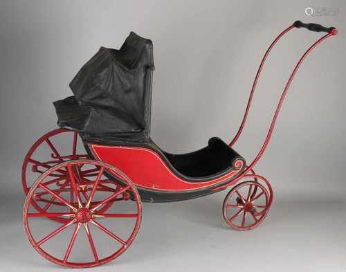 Rare 19th century toy doll carriage with leather booth, original painted frame and wire wheels.