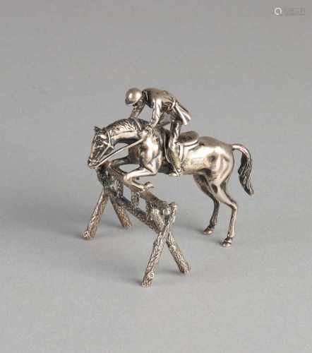 Silver miniature, 835/000, a jockey on horse jumping over obstacles. Italy. 8x5x7cm. about 59.9