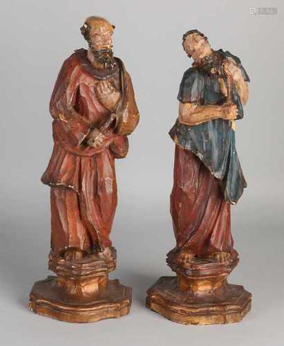 Two 18th century polychrome wood crossed religious Baroque figures with gilding on consoles. Size: H