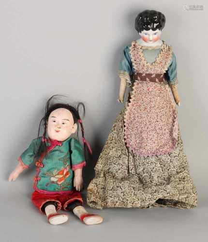 Two antique dolls. 1. Germany, 19th century porcelain cup with fabric body, original clothes. 2.