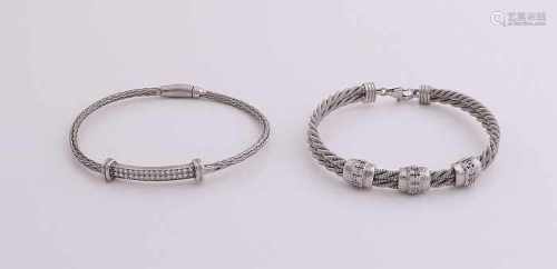 Two silver bracelets, 925/000, with cubic zirconia. Two bracelets with stiff braids adorned with