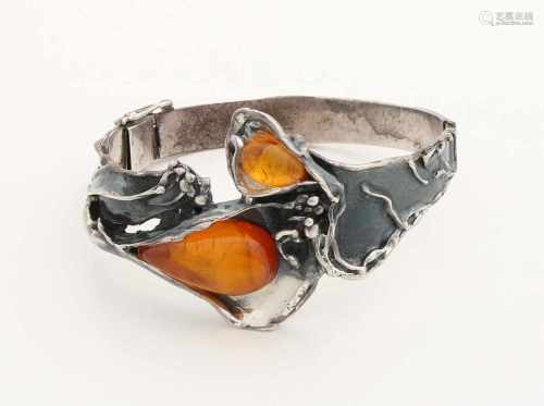 Silver slave relationship with floral decor at the upper side ahead and set with two amber. The