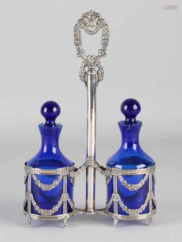 Oil and vinegar set with silver, 925/000. Silver holder decorated with garlands, rosettes and