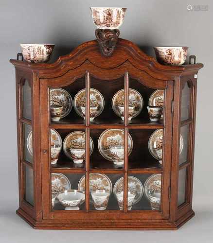 Dutch oak hanging display case with some crockery. English. Fifteen pieces. Circa 1900. Some damage.