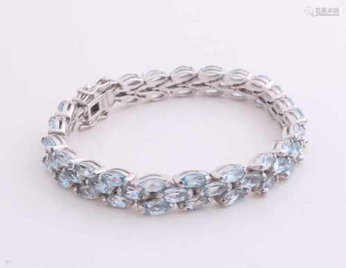 Beautiful silver bracelet, 925/000, with three rows includes marquis cut genuine blue topaz. With