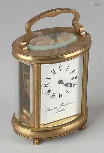 Old brass travel clock. Oval-shaped. Two half of 20th century. Charles Frodsham London. Size: 15 x