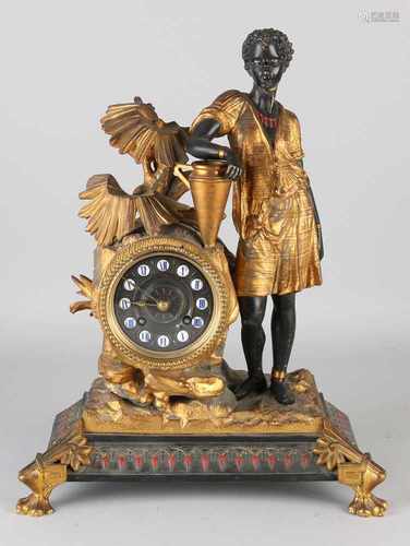 19th Century French pendulum clock with negroid figure, palm type and vase. Eight day-movement,