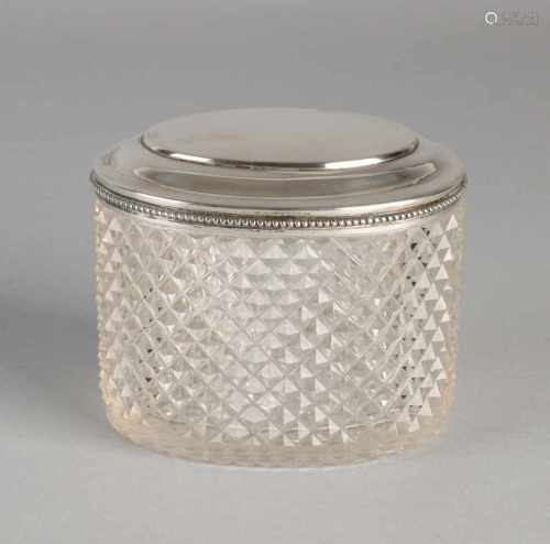 Antique oval-cut crystal, and a caddy with diamantslijpsel 835/000 silver raised lid edge with