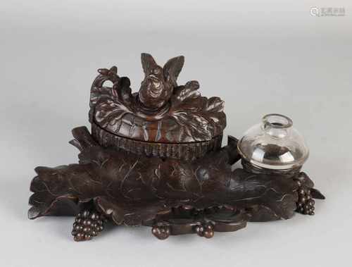 Antique Black Forest carved walnut desk set with pen holder, ink pot and lid box with golden