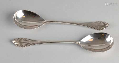 Two silver serving spoons, 833/000, with a pear-shaped bowl and a stem with fan pattern. MT. J.M.